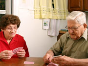 Picture of elderly couple playing cards.
