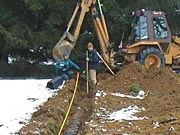 Picture of a contractor is shown installing an Individual Sewage Treatment System.