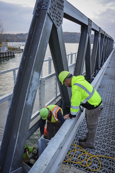Photograph of Construction workers on a bridge working