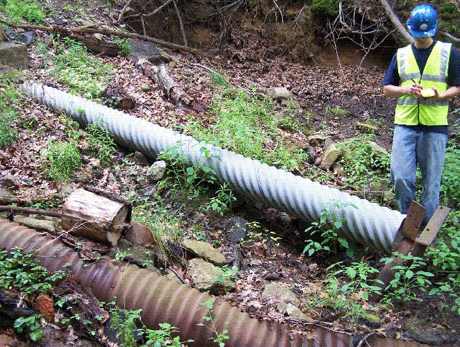 Picture showing a worker collecting GPS data for a drainage pipe.
