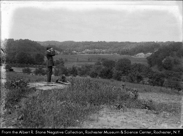 A man with binoculars looks at land that would become Ellison Park around 1922.