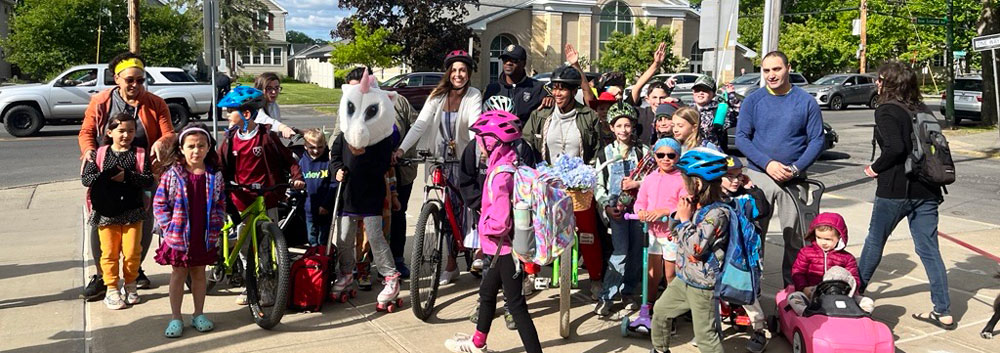 Photo of group of people with children on bikes